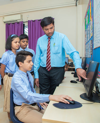 students collaborating in the computer lab at podar education school